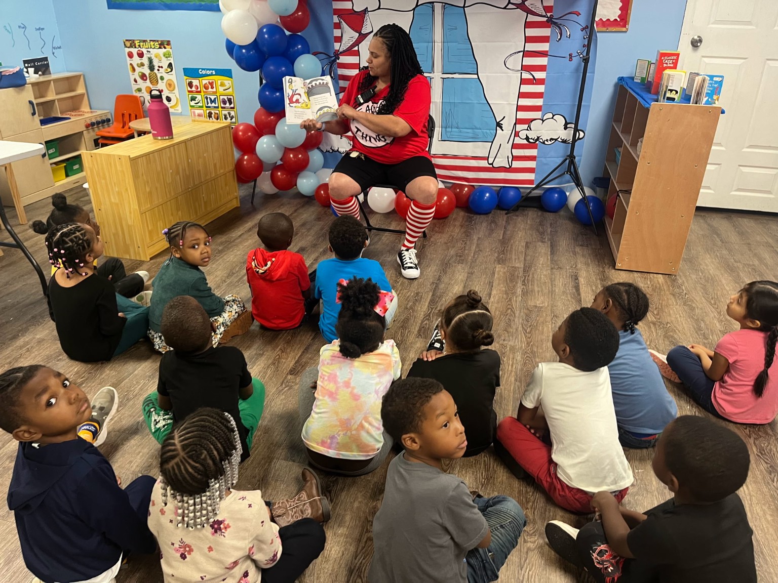 Young World children gathered for story time with a teacher